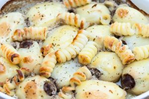 Baked potatoes stuffed with minced meat closeup.