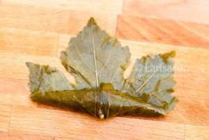 Steps of cooking dolma(tolma, sarma) from grape leaves stuffed with minced meat and rice.