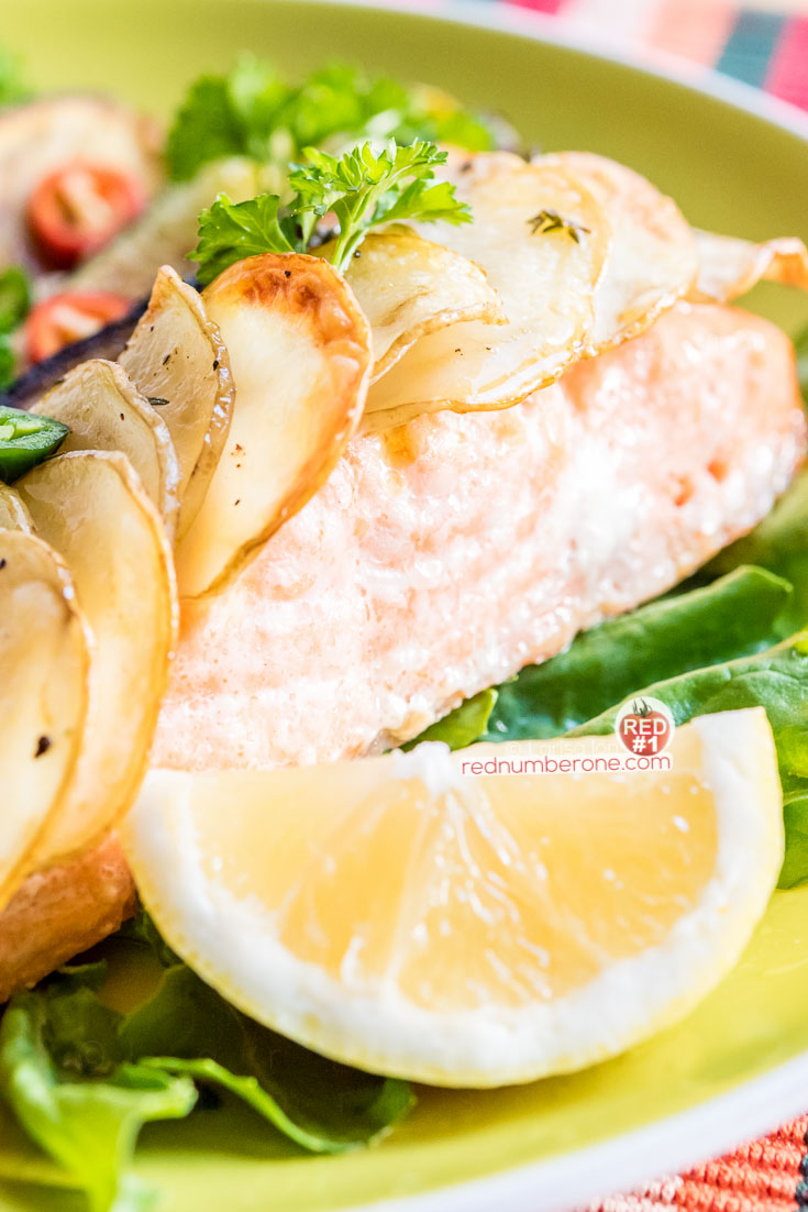 Salmon fillet with salad and potato scales